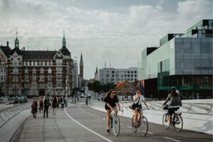 People biking over bridge in Copenhagen